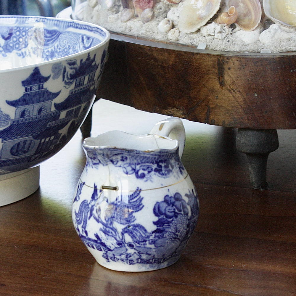 a small antique willow pattern transferware jug.