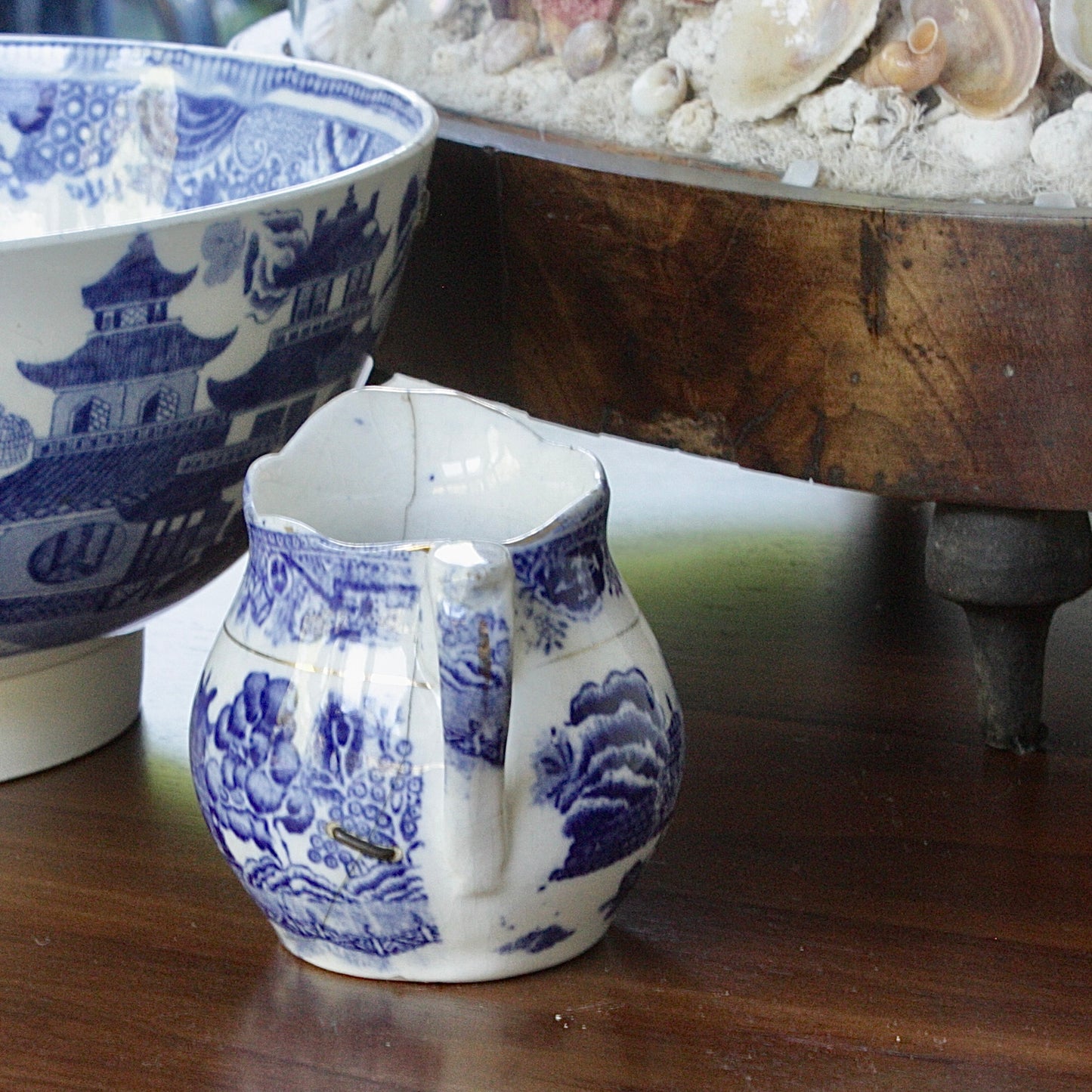 
                  
                    a small antique willow pattern transferware jug.
                  
                