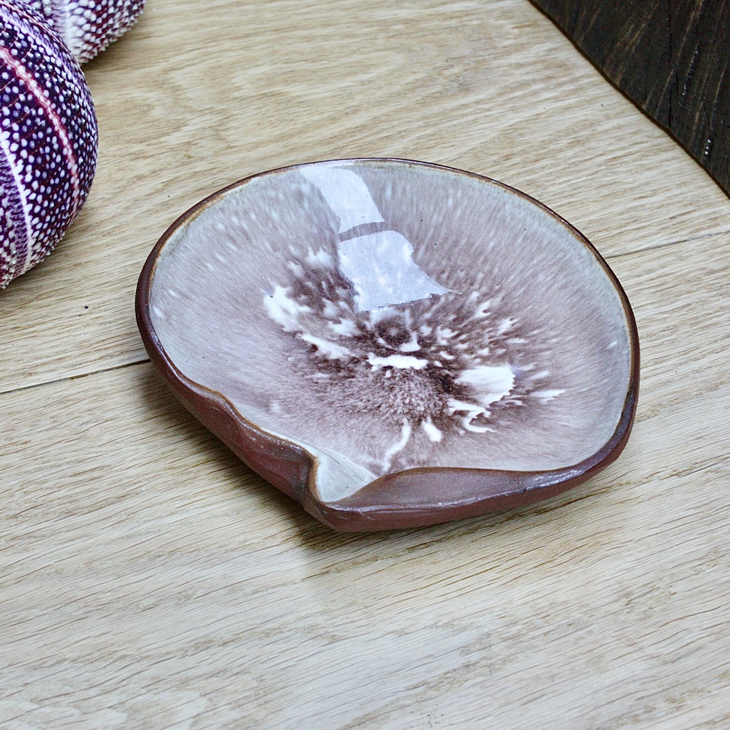 
                  
                    a studio pottery dish fashioned as a life size mother of pearl shell by humfrey wakefield.
                  
                