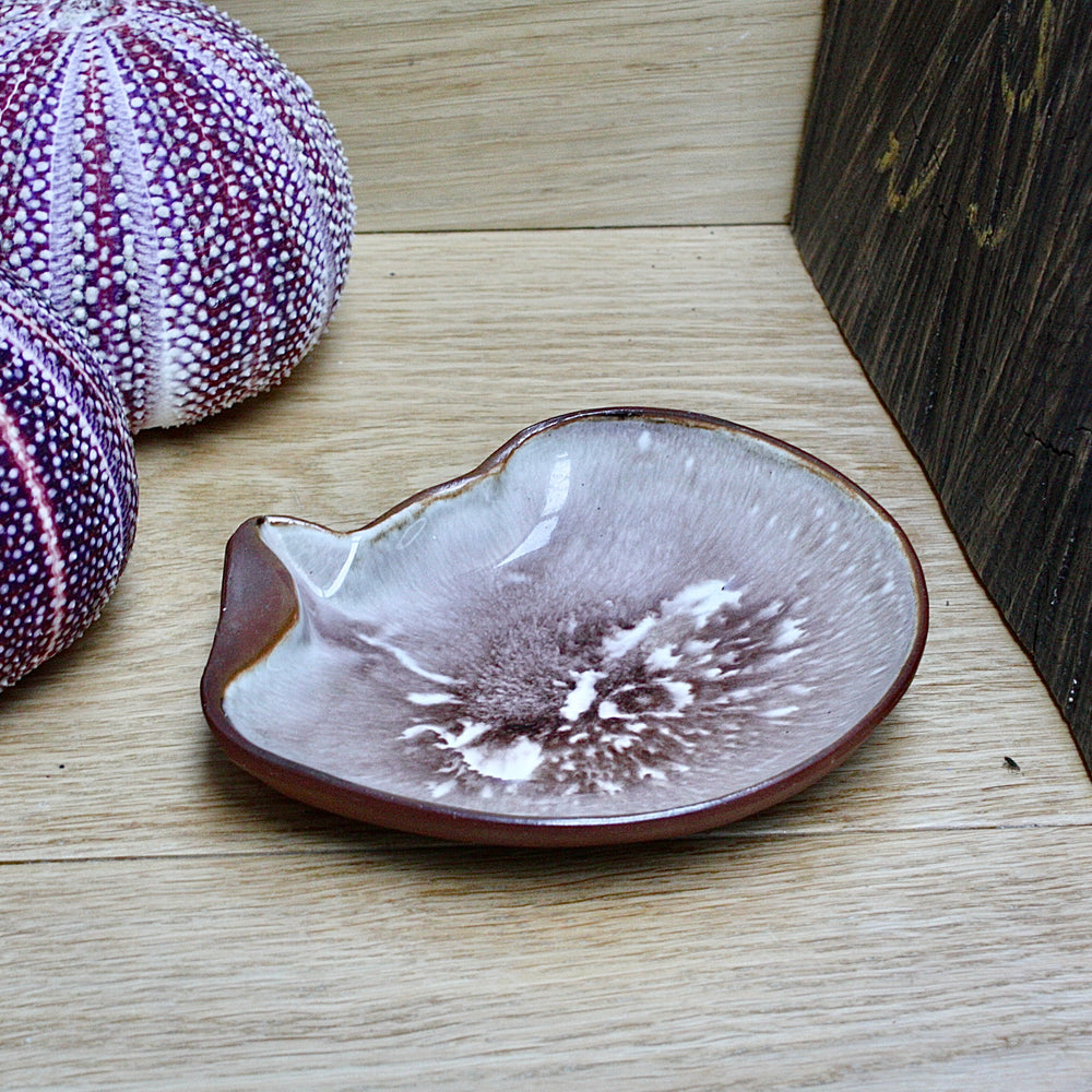 
                  
                    a studio pottery dish fashioned as a life size mother of pearl shell by humfrey wakefield.
                  
                