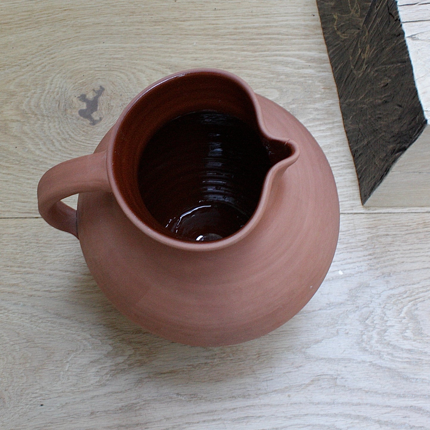 
                  
                    a large early lakes Cornish pottery Truro  jug.
                  
                