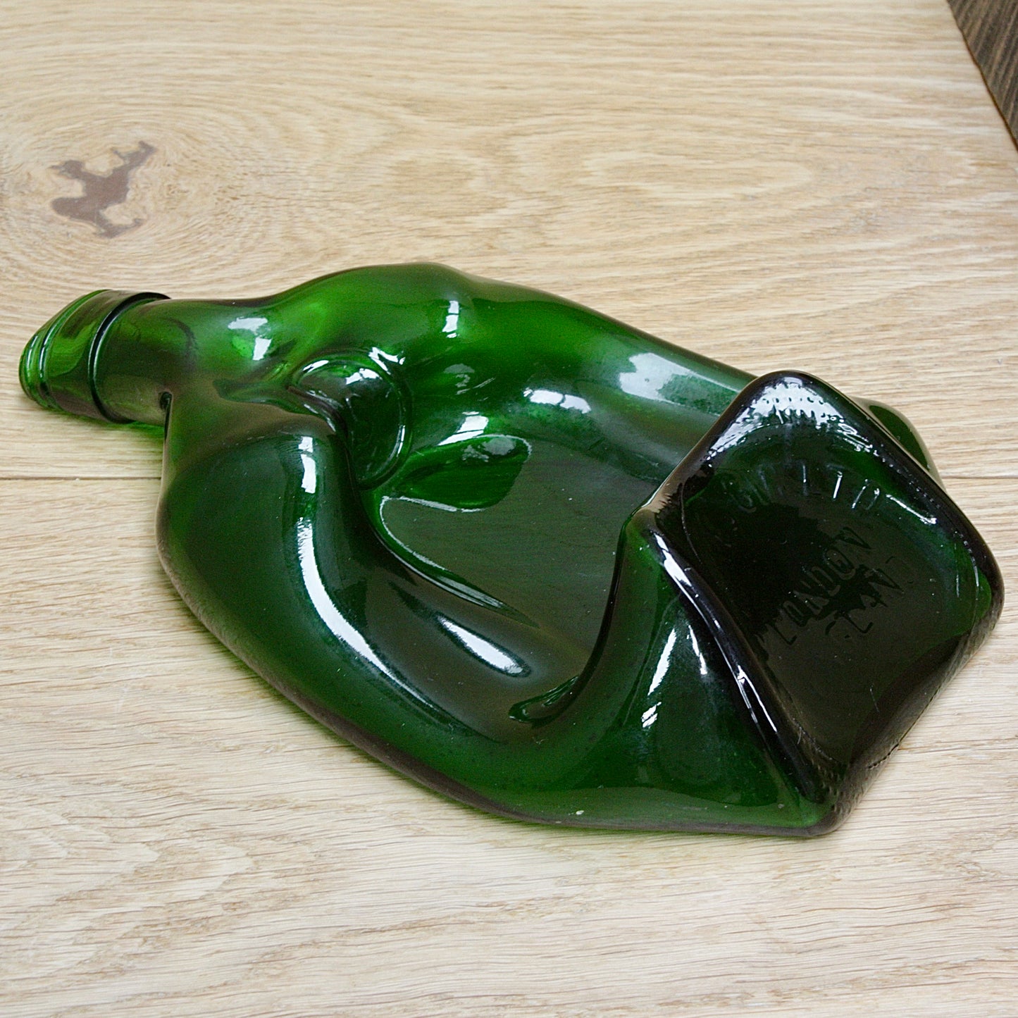 
                  
                    "the squashed bottle " by  reg moon
                  
                