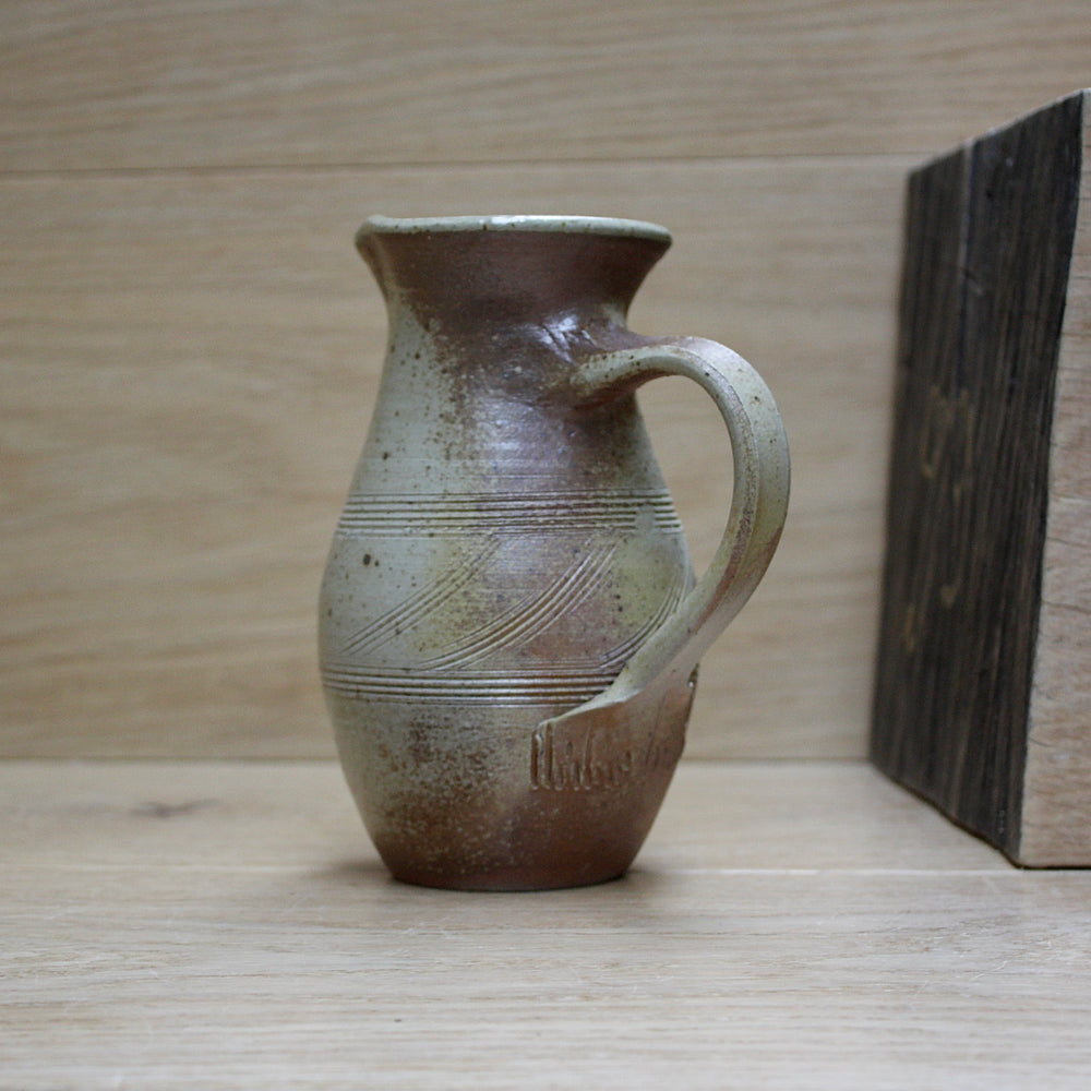 
                  
                    a studio pottery salt gaze jug.
                  
                