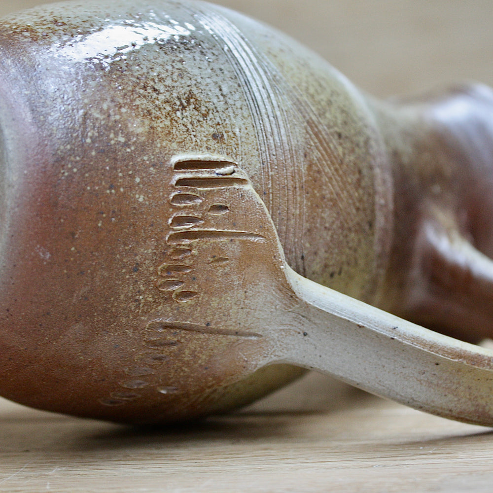 
                  
                    a studio pottery salt gaze jug.
                  
                